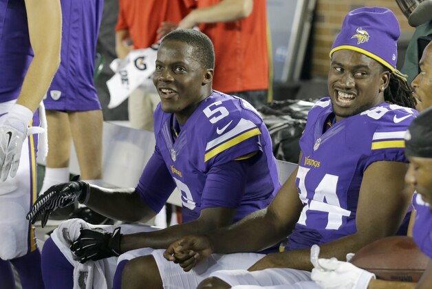 Minnesota Vikings quarterback Teddy Bridgewater (5) and wide receiver Cordarrelle Patterson, right, watch from the bench during the final seconds of an NFL preseason football game against the Arizona Cardinals, Saturday, Aug. 16, 2014, in Minneapolis. The Vikings won 30-28. (AP Photo/Ann Heisenfelt)
