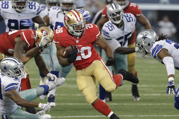 San Francisco 49ers running back Carlos Hyde (28) finds an opening against the Dallas Cowboys defense during the second half of an NFL football game, Sunday, Sept. 7, 2014, in Arlington, Texas. (AP Photo/LM Otero)