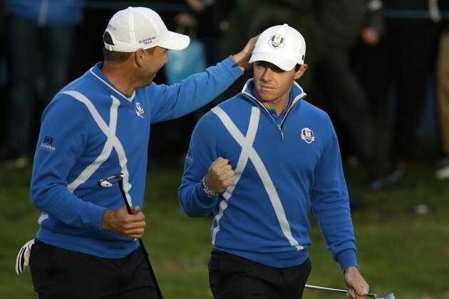 Europe’s Sergio Garcia, left, and Rory McIlroy, right, celebrate winning the 17th hole during the foursomes match on the first day of the Ryder Cup golf tournament at Gleneagles, Scotland, Friday, Sept. 26, 2014. (AP Photo/Matt Dunham)