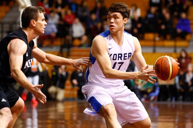 AUCKLAND, NEW ZEALAND - JULY 19: Seoung Hyunm Lee of Korea looks to pass around Kirk Penney of New Zealand during the international match between the New Zealand Tall Blacks and South Korea at North Shore Events Centre on July 19, 2014 in Auckland, New Zealand.  (Photo by Phil Walter/Getty Images)