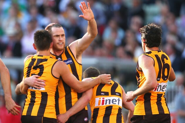 MELBOURNE, AUSTRALIA - SEPTEMBER 27:  Jarryd Roughead of the Hawks is congratulated by team mates after kicking a goal during the 2014 AFL Grand Final match between the Sydney Swans and the Hawthorn Hawks at Melbourne Cricket Ground on September 27, 2014 in Melbourne, Australia.  (Photo by Quinn Rooney/Getty Images)