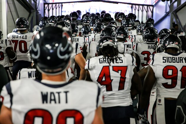 DENVER, CO - AUGUST 23:  The Houston Texans, including J.J. Watt #99, stand in the tunnel before running out to play against the Denver Broncos during a preseason game at Sports Authority Field at Mile High on August 23, 2014 in Denver, Colorado.  (Photo by Justin Edmonds/Getty Images)