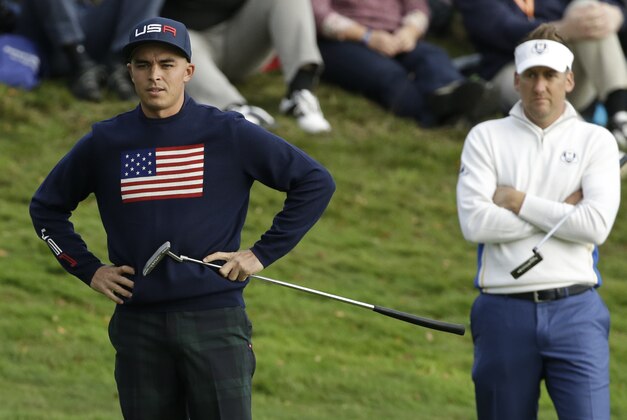 Rickie Fowler of the US looks at his missed putt on the 4th green as Europe's Ian Poulter looks on during the fourball match on the second day of the Ryder Cup golf tournament, at Gleneagles, Scotland, Saturday, Sept. 27, 2014. (AP Photo/Matt Dunham)
