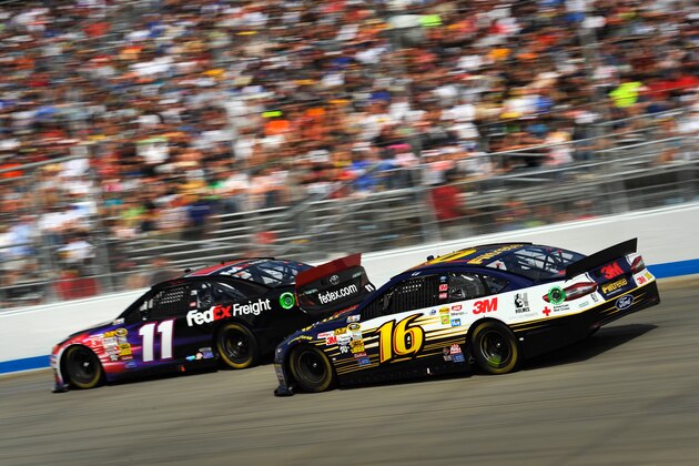 DOVER, DE - SEPTEMBER 29:  Denny Hamlin, driver of the #11 FedEx Freight Toyota, leads Greg Biffle, driver of the #16 Filtrete Ford, during the NASCAR Sprint Cup Series AAA 400 at Dover International Speedway on September 29, 2013 in Dover, Delaware.  (Photo by Jared C. Tilton/Getty Images)