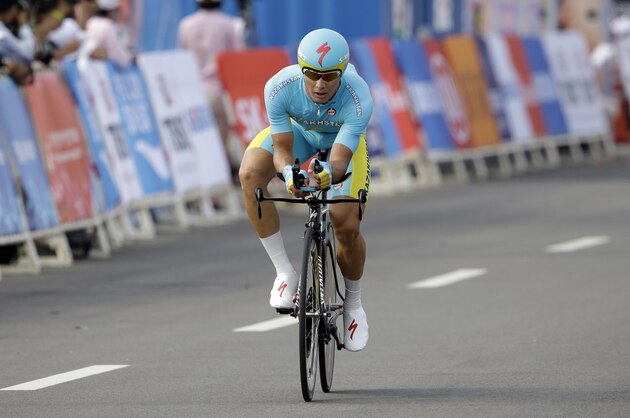 Gold medalist Kazakhstan's Alexey Lutsenko crossed the finish line in the men's cycling road individual time trial at the 17th Asian Games in Incheon, South Korea, Saturday, Sept. 27, 2014. (AP Photo/Lee Jin-man)