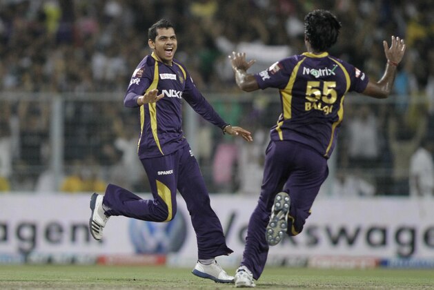 Kolkata Knight Riders' Sunil Narine, left and Lakshmipathy Balaji celebrate the dismissal of Chennai Super Kings' Murali Vijay during an Indian Premier League (IPL) cricket match in Kolkata, India, Monday, May 14, 2012. (AP Photo/Bikas Das)