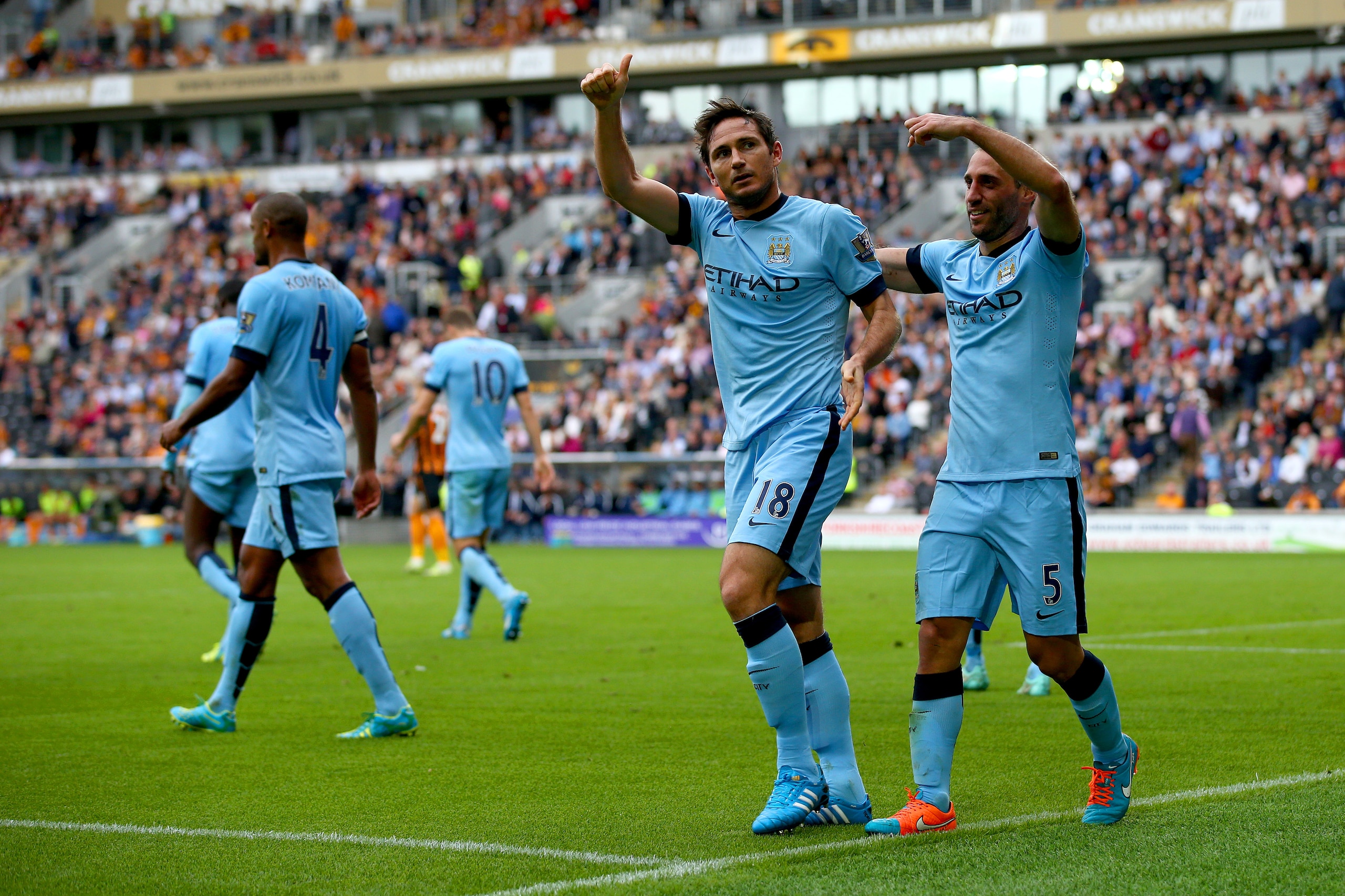 HULL, ENGLAND - SEPTEMBER 27:  Frank Lampard of Manchester City celebrates with team-mate Pablo Zabaleta after scoring his team's fourth goal during the Barclays Premier League match between Hull City and Manchester City at KC Stadium on September 27, 2014 in Hull, England.  (Photo by Matthew Lewis/Getty Images)
