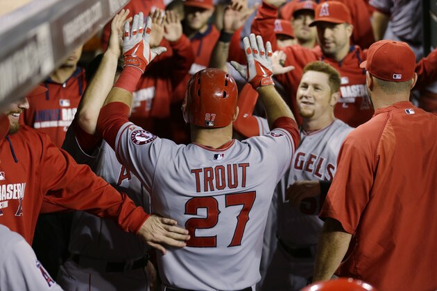Los Angeles Angels' Mike Trout (27) is greeted in the dugout during a baseball game against the Seattle Mariners, Friday, Sept. 26, 2014, in Seattle. (AP Photo/Ted S. Warren)