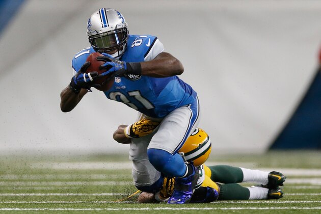 DETROIT, MI - SEPTEMBER 21: Calvin Johnson #81 of the Detroit Lions tires to avoid the tackle in the third quarter while playing the Green Bay Packers at Ford Field on September 21, 2014 in Detroit, Michigan. (Photo by Gregory Shamus/Getty Images)