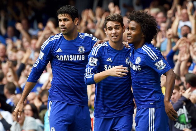 Chelsea’s Oscar, centre, celebrates scoring his teams' first goal, with Chelsea’s Diego Costa, left, and Chelsea’s Willian, who both later scored a goal each, during their English Premier League soccer match against Aston Villa at Stamford Bridge, London, Saturday, Sept. 27, 2014. (AP Photo/Tim Ireland)
