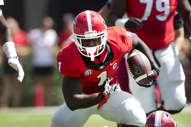 DUPLICATE***Georgia running back Sony Michel (1) gets past Troy defensive back Montres Kitchens (1) in the first half of an NCAA college football game Saturday, Sept. 20, 2014, in Athens, Ga. (AP Photo/John Bazemore)