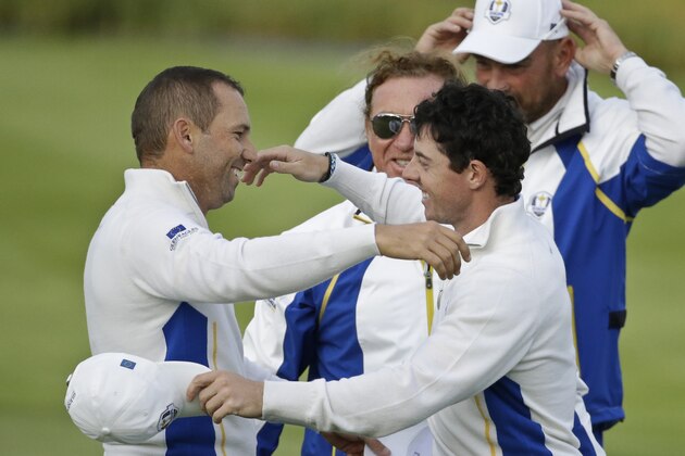 Europe's Rory McIlroy and Sergio Garcia, left, embrace on the 16th green as vice captain Miguel Angel Jimenez, center, and Thomas Bjorn, right, look on after winning their foursomes match on the second day of the Ryder Cup golf tournament, at Gleneagles, Scotland, Saturday, Sept. 27, 2014. (AP Photo/Matt Dunham) Europe's Rory McIlroy and Sergio Garcia, left, embrace on the 16th green as vice captain Miguel Angel Jimenez, center, and Thomas Bjorn, right, look on after winning their foursomes match on the second day of the Ryder Cup golf tournament, at Gleneagles, Scotland, Saturday, Sept. 27, 2014. (AP Photo/Matt Dunham)