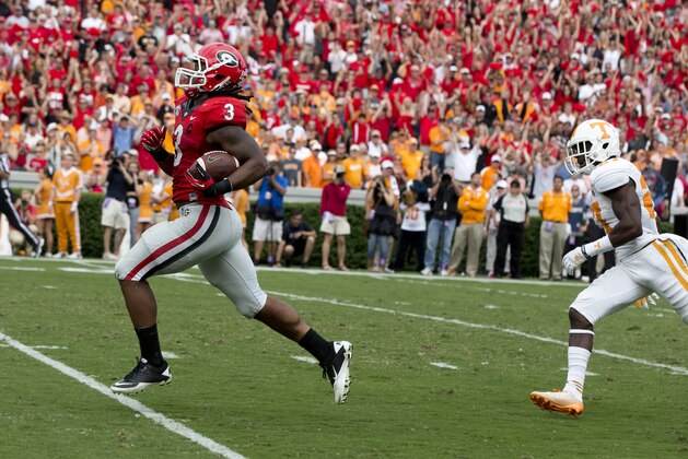 Georgia running back Todd Gurley (3) runs for a touchdown as Tennessee defensive back Justin Coleman (27) chases during the second half of an NCAA college football game  Saturday, Sept. 27, 2014, in Athens, Ga. Georgia won 35-32. (AP Photo/John Bazemore)