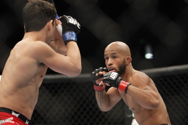 Demetrious Johnson, right, and Joseph Benavidez battle for the UFC Flyweight Mixed Martial Arts title in Sacramento, Calif., on Saturday, Dec. 14, 2013.(AP Photo/Steve Yeater)