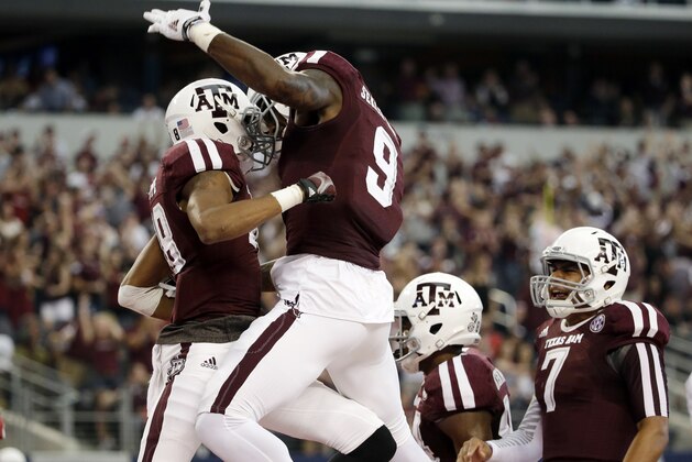Texas A&M wide receiver Edward Pope, left, celebrates with Ricky Seals-Jones (9) and Kenny Hill (7) after Pope grabbed a pass from Hill for a touchdown against Arkansas in the first half of an NCAA college football game, Saturday, Sept. 27, 2014, in Arlington, Texas. (AP Photo/Tony Gutierrez) Texas A&M wide receiver Edward Pope, left, celebrates with Ricky Seals-Jones (9) and Kenny Hill (7) after Pope grabbed a pass from Hill for a touchdown against Arkansas in the first half of an NCAA college football game, Saturday, Sept. 27, 2014, in Arlington, Texas. (AP Photo/Tony Gutierrez)