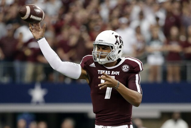 Texas A&M quarterback Kenny Hill passes against Arkansas in the first half of an NCAA college football game, Saturday, Sept. 27, 2014, in Arlington, Texas. (AP Photo/Tony Gutierrez)