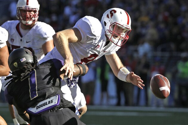 Stanford quarterback Kevin Hogan, right, fumbles the ball after being hit by Washington's Shaq Thompson (7) in the second half of an NCAA football game Saturday, Sept. 27, 2014, in Seattle. Stanford won 20-13.(AP Photo/Elaine Thompson) Stanford quarterback Kevin Hogan, right, fumbles the ball after being hit by Washington's Shaq Thompson (7) in the second half of an NCAA football game Saturday, Sept. 27, 2014, in Seattle. Stanford won 20-13.(AP Photo/Elaine Thompson)