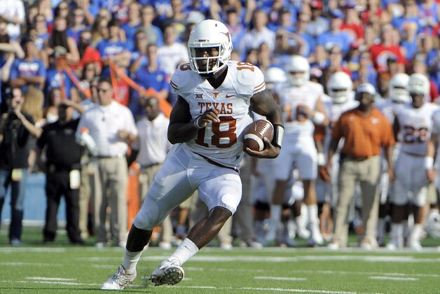 Sep 27, 2014; Lawrence, KS, USA; Texas Longhorns quarterback Tyrone Swoopes (18) rushes for a touchdown against the Kansas Jayhawks in the first half at Memorial Stadium. Mandatory Credit: John Rieger-USA TODAY Sports