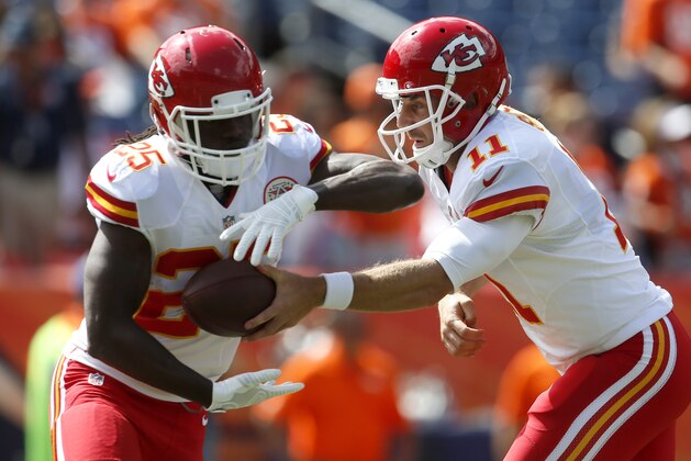 Kansas City Chiefs quarterback Alex Smith (11) and Jamaal Charles (25) warm up prior to an NFL football game against the Denver Broncos, Sunday, Sept. 14, 2014, in Denver. (AP Photo/Joe Mahoney)