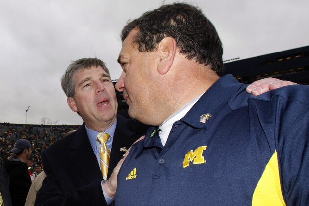 Michigan athletic director David Brandon, left, congratulates head coach Brady Hoke, right, after an NCAA college football game against Nebraska, Saturday, Nov. 19, 2011, in Ann Arbor. Michigan won 45-17. (AP Photo/Tony Ding)