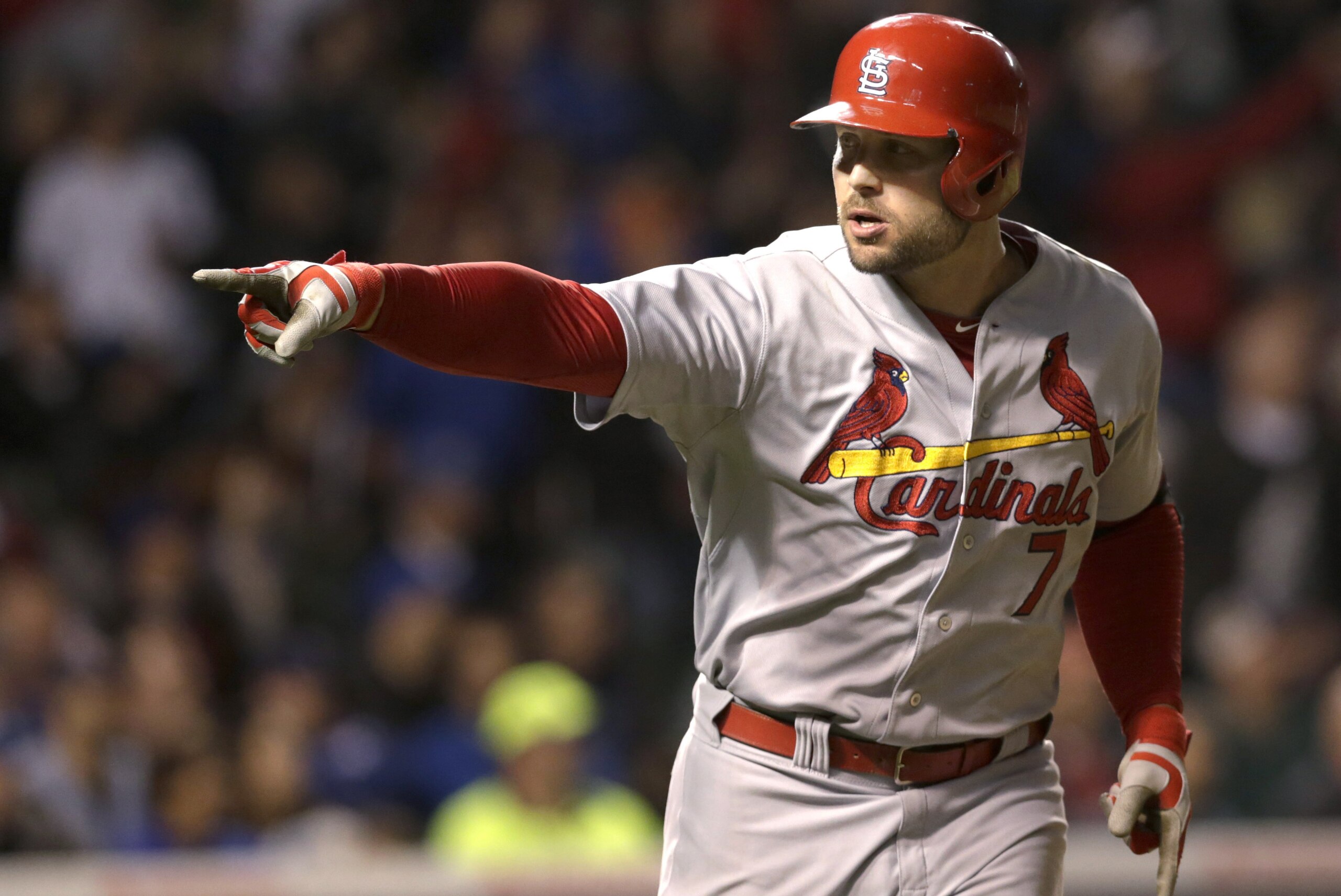 St. Louis Cardinals' Matt Holliday points into the dugout after hitting a two-run home run off Chicago Cubs starting pitcher Kyle Hendricks during the sixth inning of a baseball game Tuesday, Sept. 23, 2014, in Chicago. Matt Carpenter also scored on the play. (AP Photo/Charles Rex Arbogast)