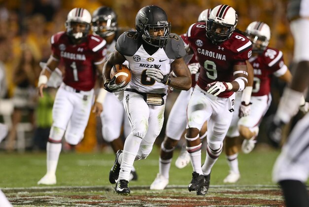 Sep 27, 2014; Columbia, SC, USA;  Missouri Tigers running back Marcus Murphy (6) breaks into the secondary past South Carolina Gamecocks linebacker Sharrod Golightly (9)  during the second quarter at Williams-Brice Stadium. Mandatory Credit: Jim Dedmon-USA TODAY Sports