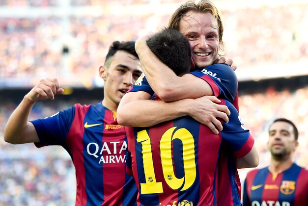 BARCELONA, SPAIN - SEPTEMBER 27:  Ivan Rakitic of FC Barcelona celebrates with his teammate Lionel Messi of FC Barcelona after scoring his team's second goal during the La Liga match between FC Barcelona and Granada CF at Camp Nou on September 27, 2014 in Barcelona, Spain.  (Photo by David Ramos/Getty Images)