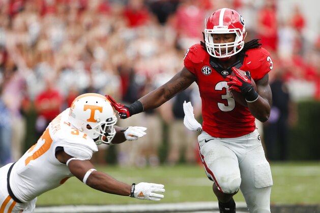 Georgia running back Todd Gurley (3) tries to break free from Tennessee defensive back Brian Randolph (37) in the second half of an NCAA college football game  Saturday, Sept. 27, 2014, in Athens, Ga. Georgia won 35-32. (AP Photo/John Bazemore)