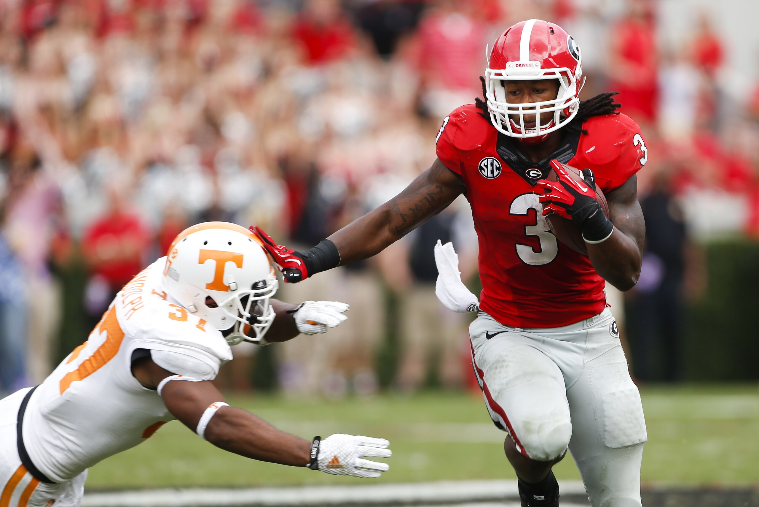 Georgia running back Todd Gurley (3) tries to break free from Tennessee defensive back Brian Randolph (37) in the second half of an NCAA college football game  Saturday, Sept. 27, 2014, in Athens, Ga. Georgia won 35-32. (AP Photo/John Bazemore)