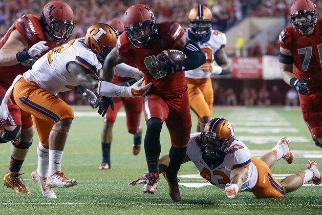 Nebraska running back Ameer Abdullah (8) runs past a tackle by Illinois linebacker T.J. Neal, left, and linebacker Mason Monheim (43) for a touchdown in the first half of an NCAA college football game in Lincoln, Neb., Saturday, Sept. 27, 2014. (AP Photo/Nati Harnik)