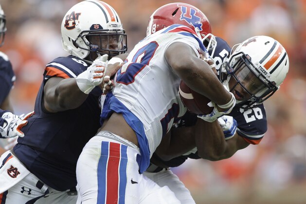 Sep 27, 2014; Auburn, AL, USA;  Auburn Tigers linebacker Justin Garrett (26) and defensive back Jonathon Mincy (6) tackle Louisiana Tech Bulldogs running back Kenneth Dixon (28) during the first half at Jordan Hare Stadium. Mandatory Credit: John Reed-USA TODAY Sports