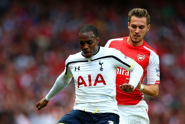 LONDON, ENGLAND - SEPTEMBER 27: Danny Rose of Spurs holds off a challenge from Aaron Ramsey of Arsenal during the Barclays Premier League match between Arsenal and Tottenham Hotspur at Emirates Stadium on September 27, 2014 in London, England. (Photo by Paul Gilham/Getty Images) LONDON, ENGLAND - SEPTEMBER 27: Danny Rose of Spurs holds off a challenge from Aaron Ramsey of Arsenal during the Barclays Premier League match between Arsenal and Tottenham Hotspur at Emirates Stadium on September 27, 2014 in London, England. (Photo by Paul Gilham/Getty Images)