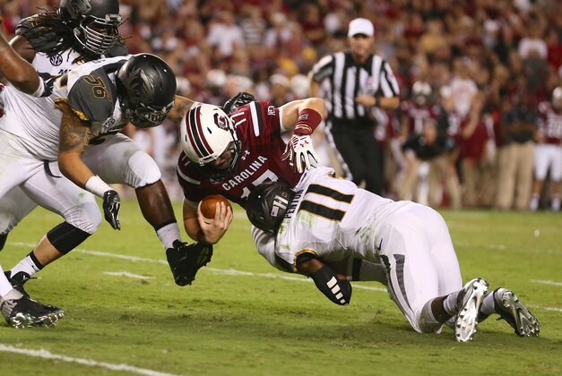 Sep 27, 2014; Columbia, SC, USA;  South Carolina Gamecocks quarterback Dylan Thompson (17) is tackled by Missouri Tigers defensive back Aarion Penton (11) during the third quarter at Williams-Brice Stadium. Mandatory Credit: Jim Dedmon-USA TODAY Sports