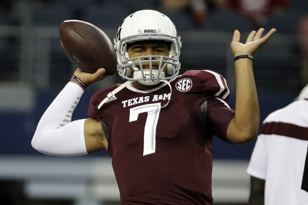 Texas A&M quarterback Kenny Hill passes as he warms up before an NCAA college football game against Arkansas, Saturday, Sept. 27, 2014, in Arlington, Texas. (AP Photo/Tony Gutierrez)