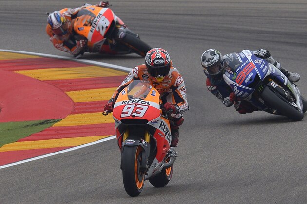 MotoGP raider Marc Marquez of Spain steers his motorcycle followed by Jorge Lorenzo and Dani Pedrosa during the MotoGP race at the Aragon Motorcycle Grand Prix in Alcaniz, Spain, Sunday, Sept. 28, 2014.  (AP Photo/Manu Fernandez)