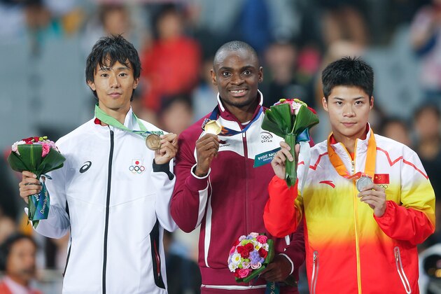 INCHEON, SOUTH KOREA - SEPTEMBER 28: (L-R) Bronze medalist Kei Takase of Japan, gold medalist Femi Seun Ogunode of Qatar and Silver medalist Su Bingtian of China  poses for photographs during the victory ceremony for theMen's 100m Final during day nine of the 2014 Asian Games at Incheon Asiad Main Stadium on September 28, 2014 in Incheon, South Korea.  (Photo by Lintao Zhang/Getty Images)