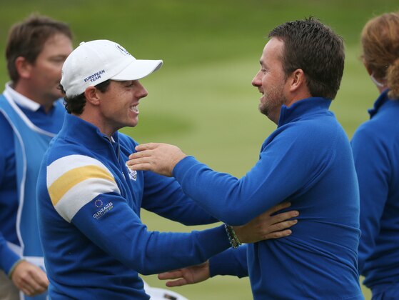 Europe’s Rory McIlroy, left, congratulates  Graeme McDowell on the 17th green after winning his singles match against Jordan Spieth of the US on the final day of the Ryder Cup golf tournament, at Gleneagles, Scotland, Sunday, Sept. 28, 2014. (AP Photo/Scott Heppell)