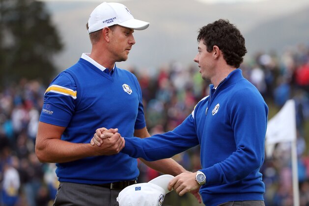 Europe’s Henrik Stenson, left, is met by Rory McIlroy on the 18th green after being defeated in his singles match by Patrick Reed of the US on the final day of the Ryder Cup golf tournament, at Gleneagles, Scotland, Sunday, Sept. 28, 2014. (AP Photo/Scott Heppell)
