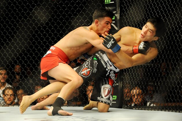Sep 27, 2014; Las Vegas, NV, USA; Dominick Cruz (red gloves) fights Takeya Mizugaki (blue gloves) during a bantamweight fight at UFC 178 at MGM Grand Garden Arena. Mandatory Credit: Stephen R. Sylvanie-USA TODAY Sports