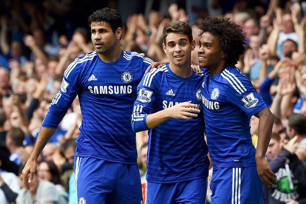 Chelsea’s Oscar, centre, celebrates scoring his teams' first goal, with Chelsea’s Diego Costa, left, and Chelsea’s Willian, who both later scored a goal each, during their English Premier League soccer match against Aston Villa at Stamford Bridge, London, Saturday, Sept. 27, 2014. (AP Photo/Tim Ireland)