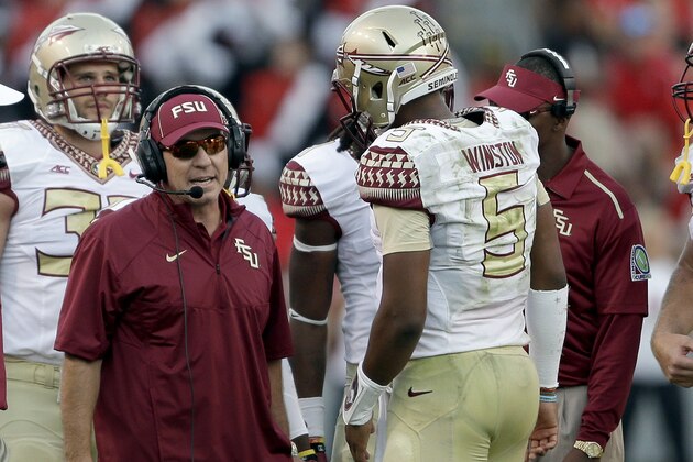 Florida State  coach Jimbo Fisher speaks with quarterback Jameis Winston (5) during the second half of an NCAA college football game against North Carolina State in Raleigh, N.C., Saturday, Sept. 27, 2014. Florida State won 56-41.(AP Photo/Gerry Broome)