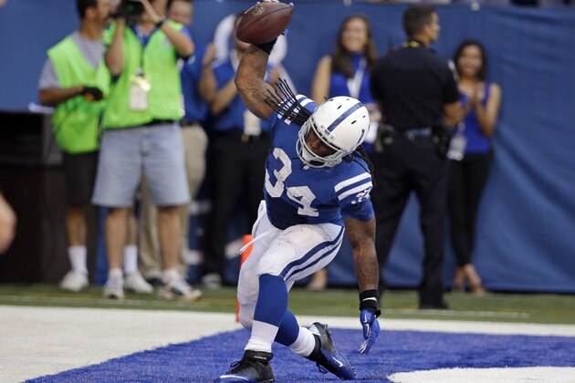 Indianapolis Colts running back Trent Richardson celebrates his touchdown against the Tennessee Titans during the first half of an NFL football game in Indianapolis, Sunday, Sept. 28, 2014. (AP Photo/Darron Cummings)