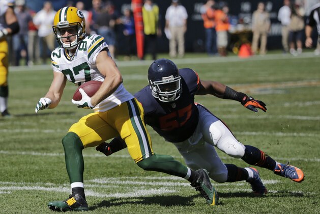 Green Bay Packers wide receiver Jordy Nelson (87) runs past Chicago Bears linebacker Jon Bostic (57) in the first half of an NFL football game Sunday, Sept. 28, 2014, in Chicago. (AP Photo/Charles Rex Arbogast)
