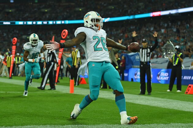Miami Dolphins' Lamar Miller celebrates after scoring a touchdown during the NFL football game against Oakland Raiders at Wembley Stadium in London, Sunday, Sept. 28, 2014. (AP Photo/Tim Ireland)
