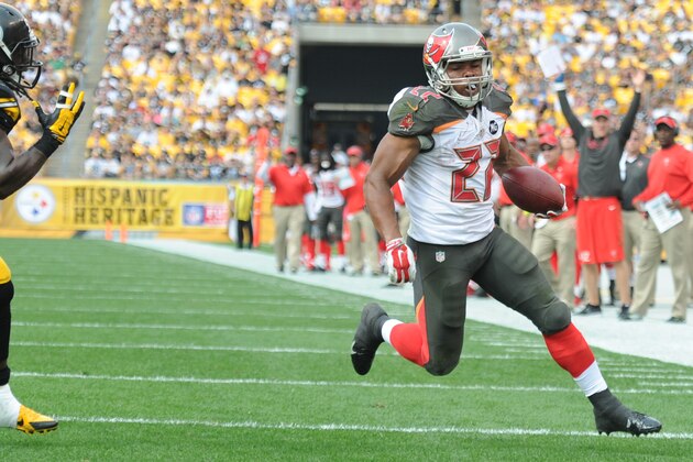 Tampa Bay Buccaneers running back Doug Martin (22) runs away from Pittsburgh Steelers linebacker Sean Spence (51) to score a touchdown in the third quarter of the NFL football game  on Sunday, Sept. 28, 2014 in Pittsburgh. (AP Photo/Don Wright)