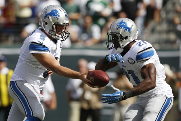 Detroit Lions quarterback Matthew Stafford, left, hands off to running back Reggie Bush during the first half of an NFL football game against the New York Jets, Sunday, Sept. 28, 2014, in East Rutherford, N.J. (AP Photo/Kathy Willens)