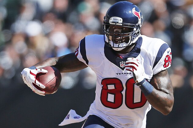 Houston Texans wide receiver Andre Johnson carries the ball in the third quarter of an NFL football game against the Oakland Raiders Sunday, Sept. 14, 2014, in Oakland, Calif. (AP Photo/Beck Diefenbach)