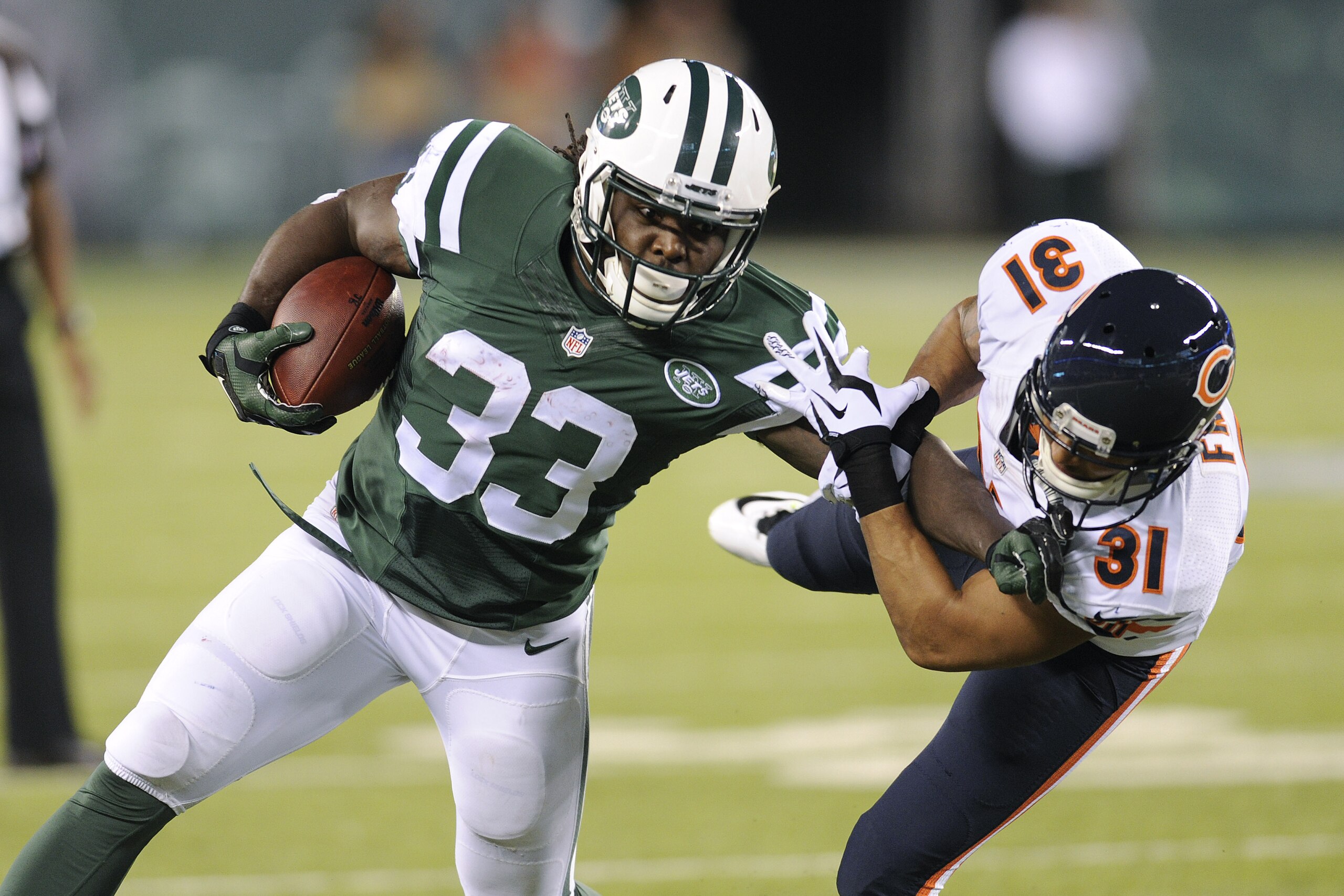 New York Jets running back Chris Ivory (33) stiff arms Chicago Bears cornerback Isaiah Frey (31) in the second quarter of an NFL football game, Monday, Sept. 22, 2014, in East Rutherford, N.J. (AP Photo/Bill Kostroun)