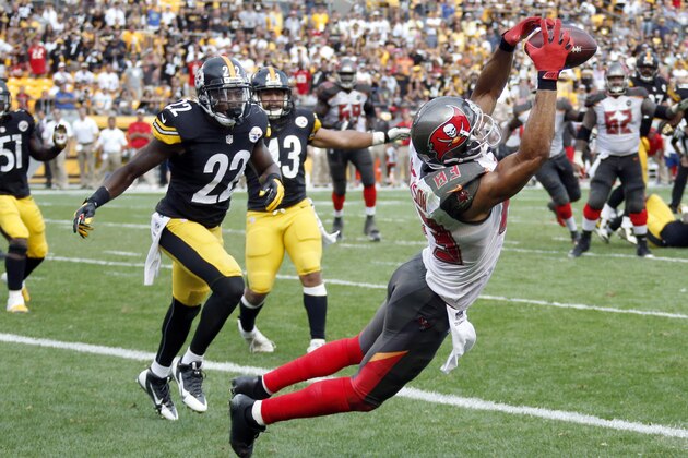 Tampa Bay Buccaneers wide receiver Vincent Jackson (83) makes a catch in front of Pittsburgh Steelers cornerback William Gay (22) for a touchdown with seven seconds left in the fourth quarter of an NFL football game on Sunday, Sept. 28, 2014 in Pittsburgh. The score lifted the Buccaneers to a 27-24 win. (AP Photo/Gene Puskar)