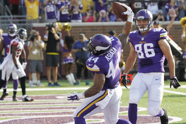 Minnesota Vikings running back Matt Asiata celebrates with teammate Chase Ford (86) after scoring on a 6-yard touchdown run in the first half of an NFL football game against the Atlanta Falcons, Sunday, Sept. 28, 2014, in Minneapolis. (AP Photo/Ann Heisenfelt)